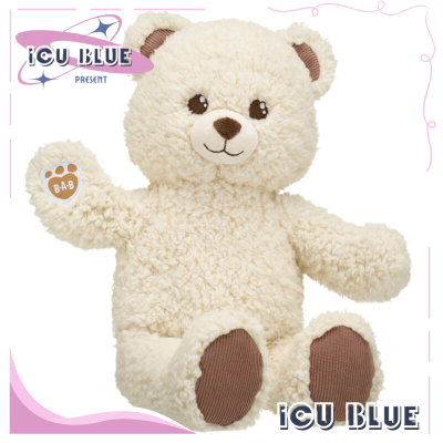 a white teddy bear with brown ears